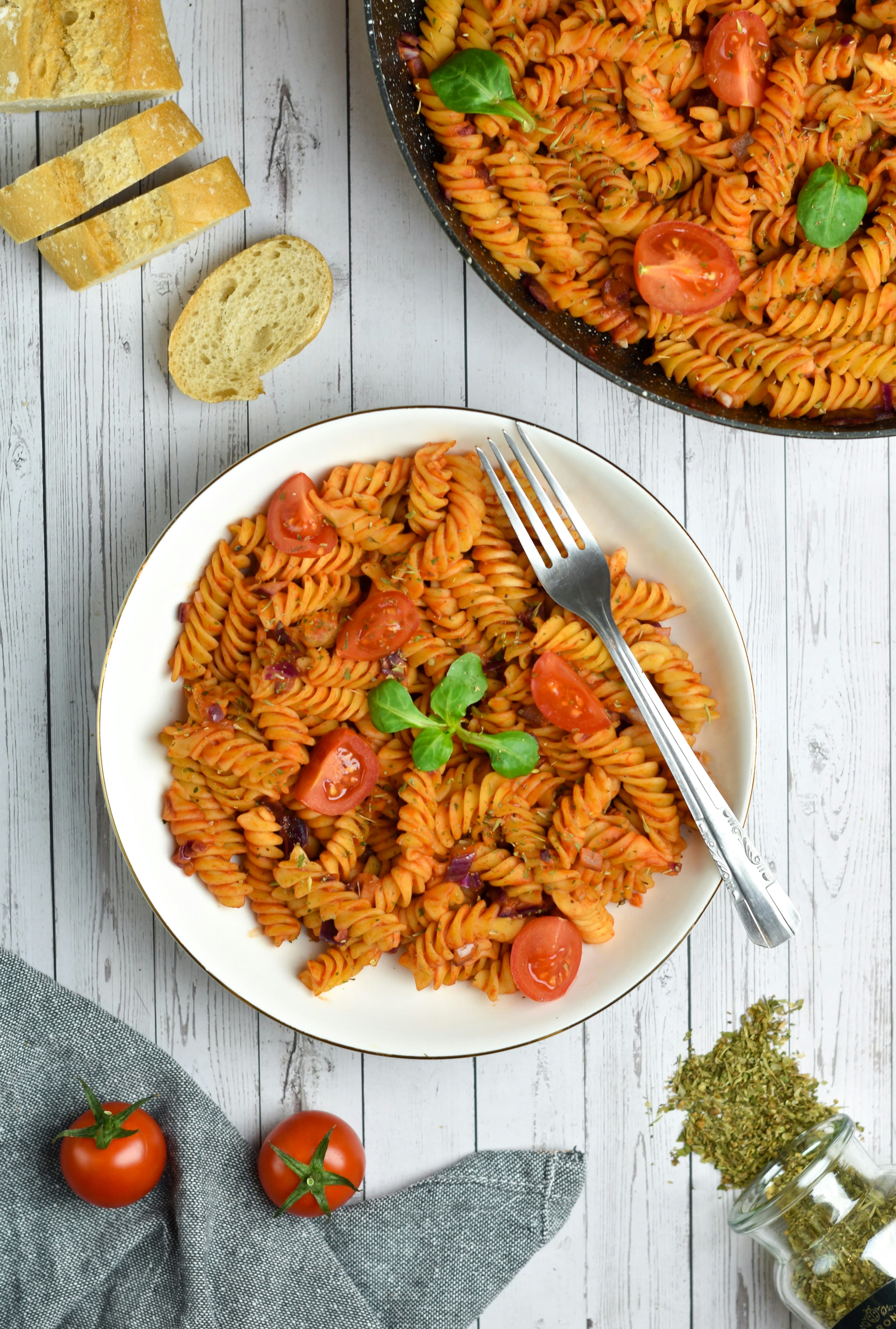 Cherry tomato pasta with burst tomatoes and fresh basil