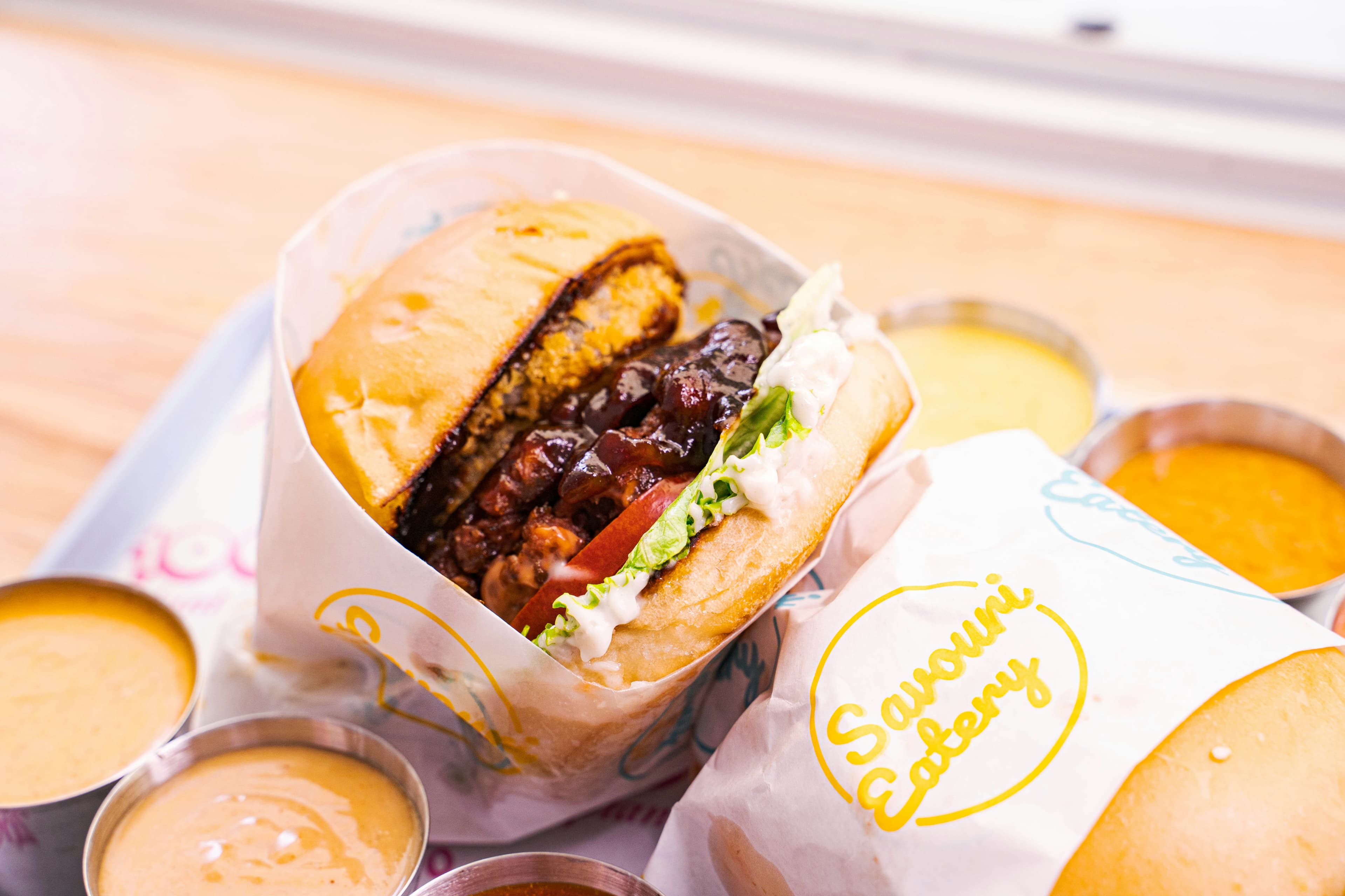 Colorful fast food burger with fresh toppings on a tray