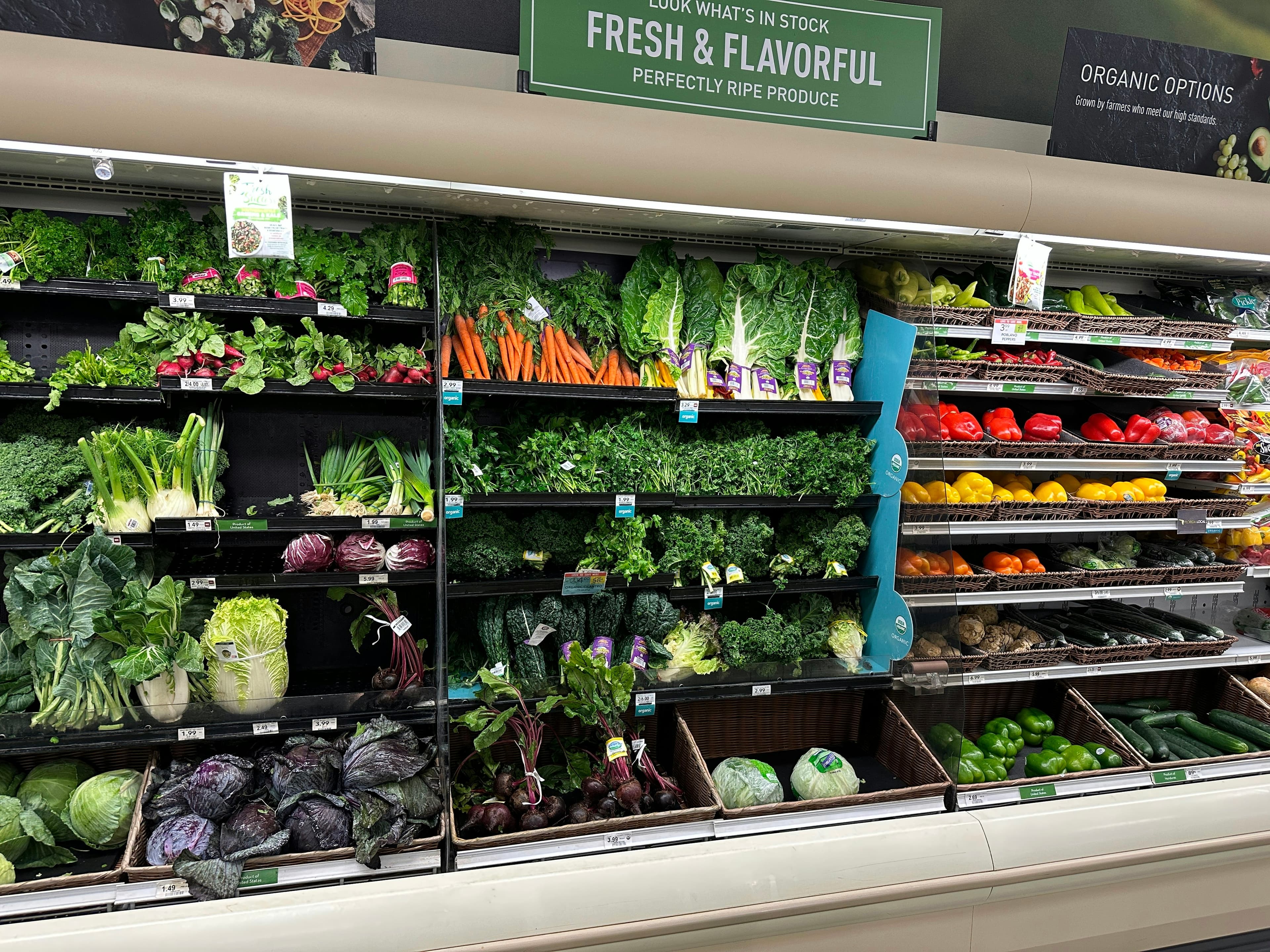 Grocery store produce aisle with fresh fruits and vegetables